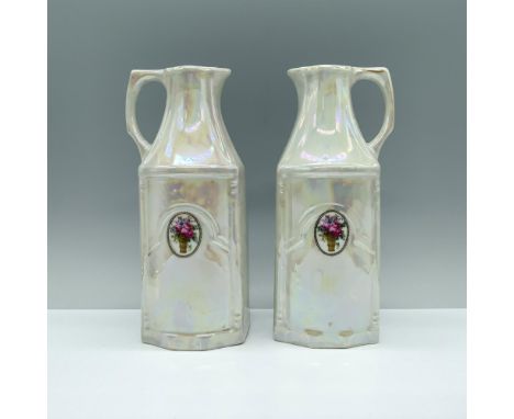 A pair of iridescent white carafes, each adorned with a striking bouquet of roses emblem in the center. White Block backstamp