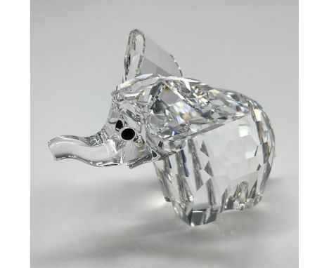 Clear, faceted crystal figural with widespread ears, trunk up and jet crystal button eyes. Swarovski backstamp. 7640 040 000.