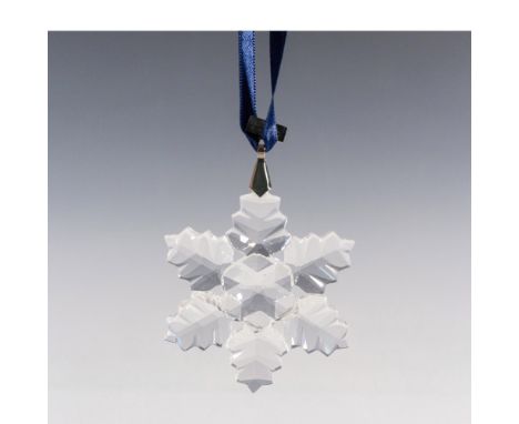 A clear tree ornament with 6 points in a form of a leaf-life design, and a metal tag with 1996 etched on it. Swarovski marked