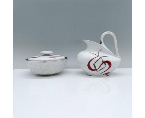 A matte white sugar bowl and creamer, beautifully decorated with black and red abstract line art. Dimensions of the largest i