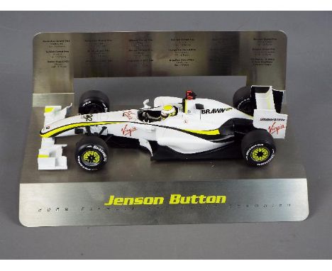 Minichamps - a 1:18 scale diecast model, Jenson Button 2009 World Championship, Brawn GP F1, the model mounted on metal stand