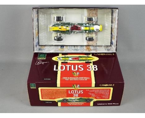 A Carousel 1 1:18 scale diecast model of a Lotus 38 1965 Indianapolis 500 racing car, finished in green and yellow with racin