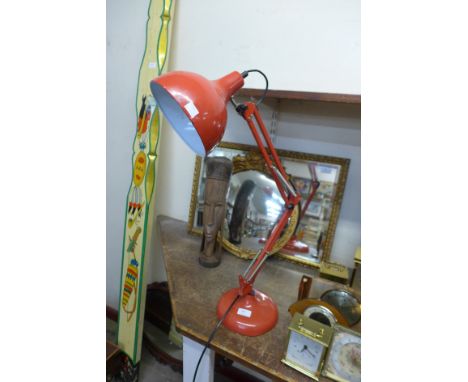 A red anglepoise lamp 