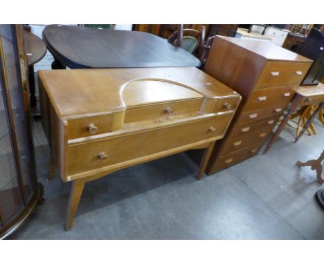 A light oak dressing table and a chest of drawers 