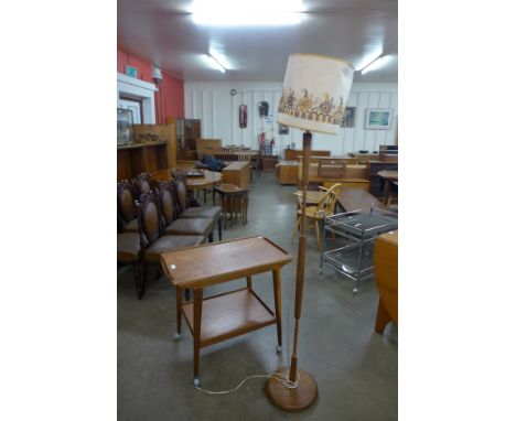A teak standard lamp and trolley 