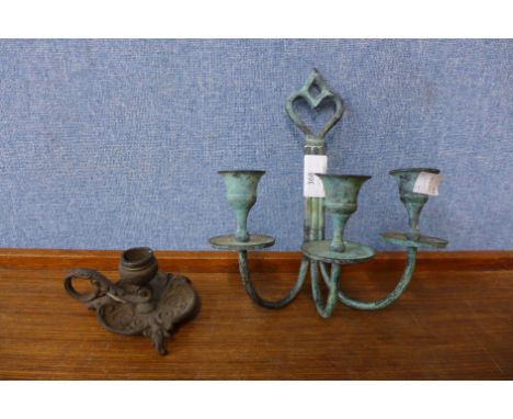 A bronze candlestick and one other 