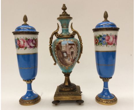 A pair of Ormolu and ceramic hand painted pedestal urns, with a twin handled pedestal urn (3) 