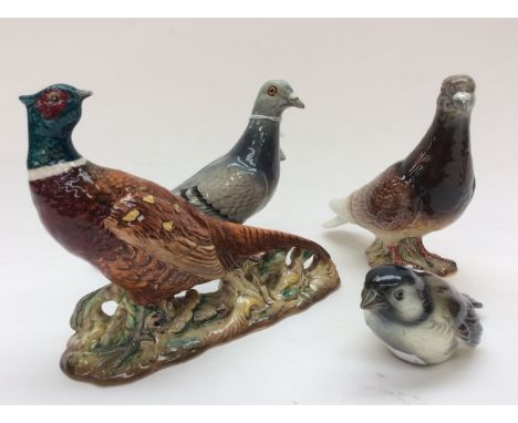 Three Beswick bird figures comprising pheasant 1226, pigeon 1383, and pigeon 1383 in grey and brown together with a Goebel ti