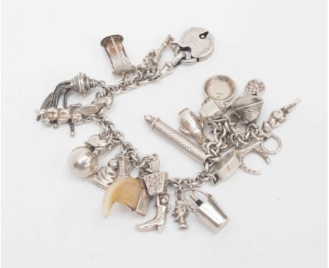 A silver charm bracelet with various charms including Victorian tassle propelling pencil, egg timer etc
