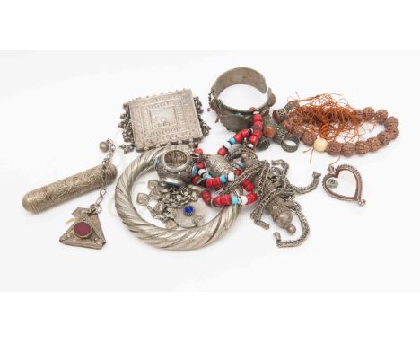 A collection of Near East and Arabian Peninsula white metal jewellery items, to include a torc, amulet prayer holders, rings 