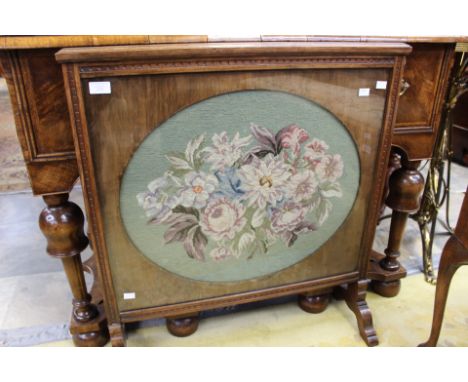An early 20th Century oak woolwork firescreen. 79cm high, 72cm wide. 