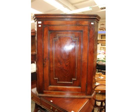 A 19th Century mahogany hanging corner cupboard fitted with a single door. A reproduction corner washstand and a mahogany Reg