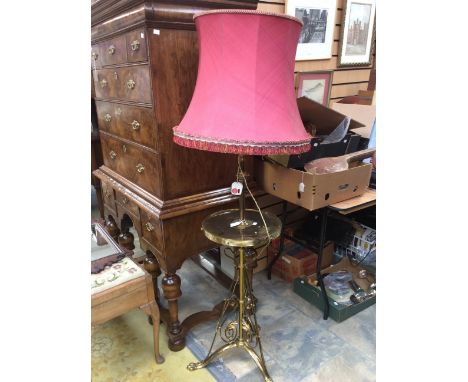 An Edwardian brass tripod floor lamp with a circular tier shelf, silk shade, height 158cm