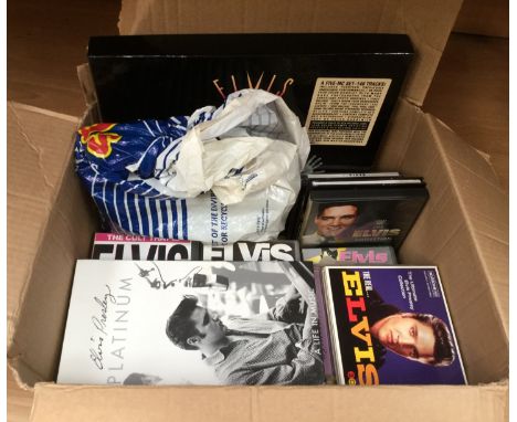 A box of Elvis memorabilia including records, cassettes, videos, etc 