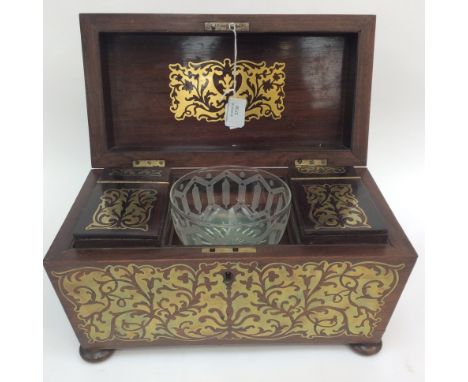 An early sarcophagus (1820s) shaped tea caddy raised on squat bun feet, the 'Boule' work inlaid brass detail, extends to the 