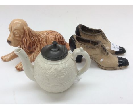 A small 1840s salt glaze teapot, two circa 1900 ceramic ladies shoes, a Sylvac dog 114 beige