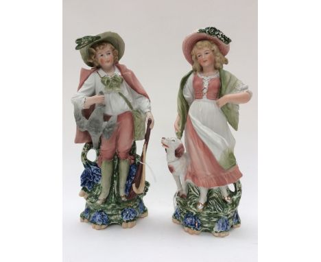 A pair of Continental German figurines, flat back style man and woman with hunting theme