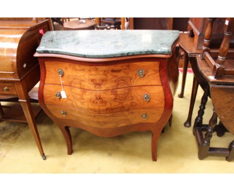 A French style marble topped commode, of Bombe form, fitted with three drawers