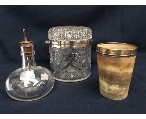 A silver rimmed horn beaker, early vinegar silver topped bottle and a cut glass silver rimmed caddy