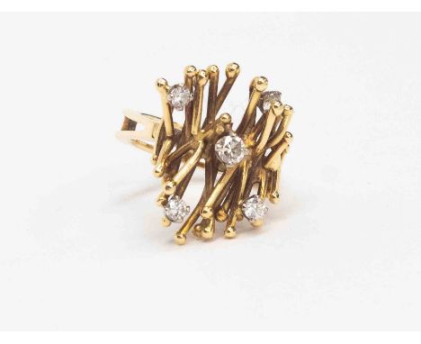 A diamond and 18ct gold asymmetric ring, with branch like details, claw set with five brilliant cut diamonds varying in size,