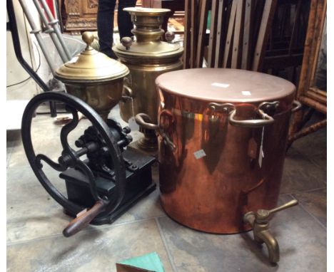 A cast and brass large coffee grinder, along with two hot water urns 