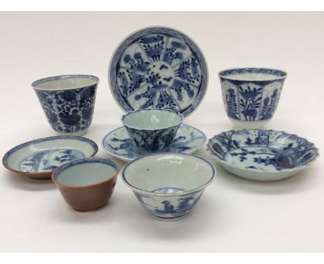A Chinese blue and white tea bowl and saucer, with shaped rim; together with two further tea bowls and saucers, one Batavian 