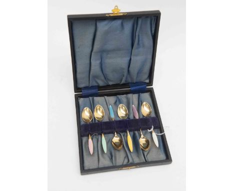 A set of six Danish, twentieth Century, silver gilt and enamel coffee spoons, each handle with engine turned enamel decoratio