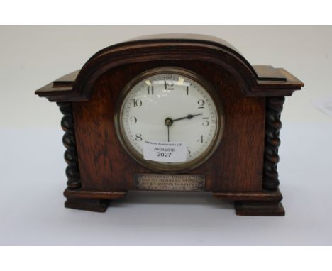 A presentation mantle clock 1928 with silver inscription cartouche, oak cased French mechanism mechanical wind with key