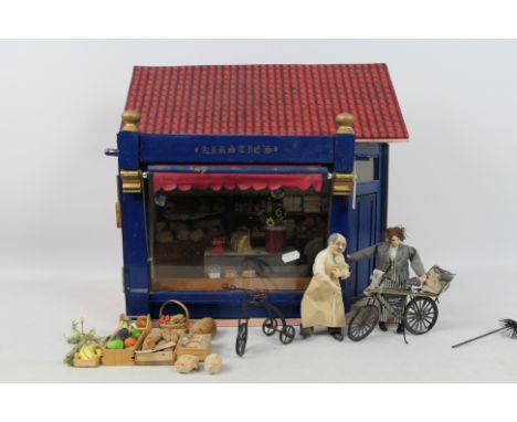 Dolls House - A scratch built wooden dolls house depicting a bakery shop entitled 'Kirsties'. The shop opens at the front, an