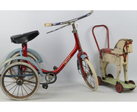 Raleigh - An unbranded vintage wooden push a long horse with a vintage Raleigh childrens trike. The white horse with red meta