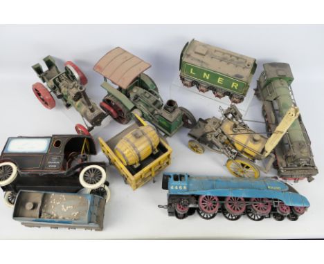 Five decorative tin plate vehicles in various scales. Lot contains two traction engines plus three trains being Rocket, Malla
