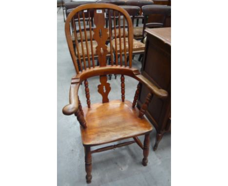 A hoop back Windsor chair with pierced vase splat and stick supports, turned front legs
