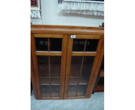 An oak glazed door three shelf bookcase, 71cm x 22cm x 91.5cm high