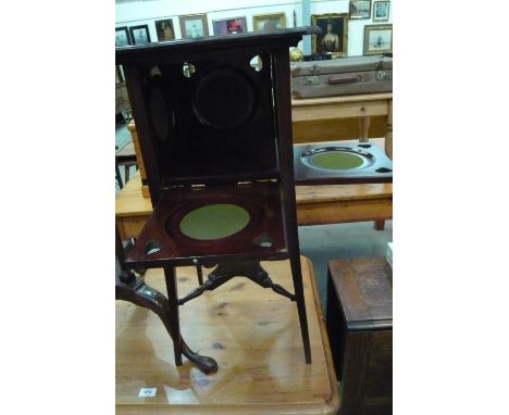 A cake stand with four folding beize stands, splayed legs, stretcher shelf and pierced heart detail to sides