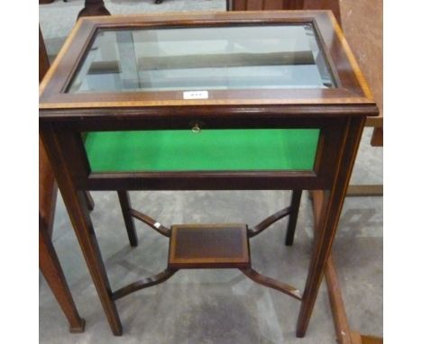 A mahogany inlaid lift top glazed bijouterie table with beize liner on tapering square legs with stretcher shelf, 57cm x 40cm