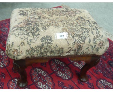 A tapestry upholstered rectangular stool on four cabriole legs