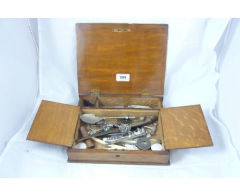 Wooden box containing penknives, caddy spoon, corkscrews etc.