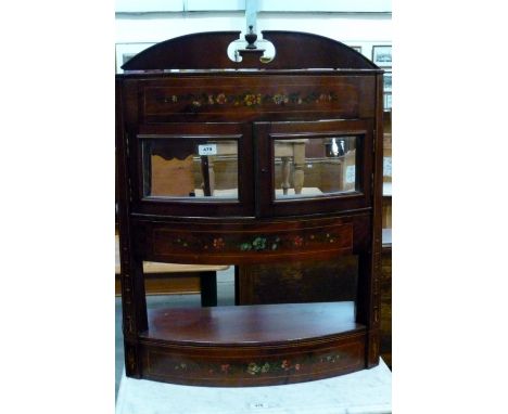 A pretty mahogany floral hand painted bow front wall hanging glazed display cabinet with urn finial with cupboard doors over 