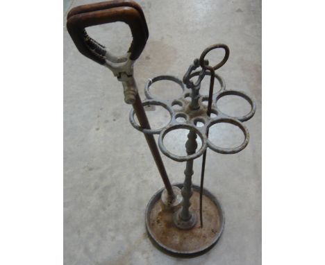 A 19th century cast iron circular stick stand with carrying handle 63.5cm high together with shooting stick