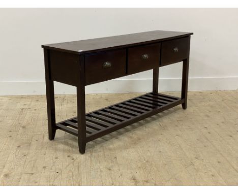 A stained hardwood console table, fitted with three drawers over square tapered supports united by a slatted pot board base, 