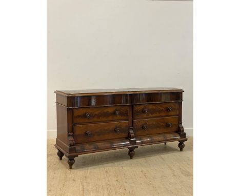 A Victorian mahogany commode or chest of drawers of serpentine outline, fitted with two frieze drawers over four drawers with