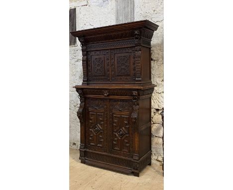 A Victorian oak  cabinet of 18th century design, the gadrooned cornice above a blind fret frieze and two carved panelled door