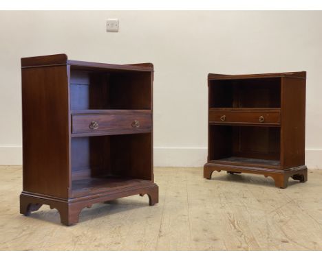 A pair of mahogany bedside tables in the Georgian taste, three quarter galleried top over open shelf and drawer, raised on br