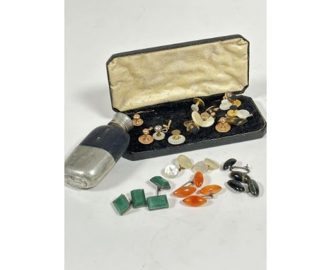 A box containing a collection of gilt metal and mother of pearl studs, a pair of green stone cushion cut sleeve links, a pair