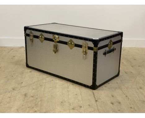 A vintage aluminium travelling trunk, with plain interior and carry handle to each end H50cm, W100cm 