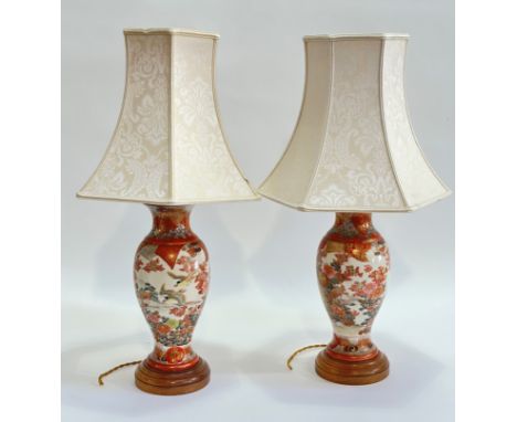 A pair of ceramic baluster shaped Kutani style table lamps, decorated with chrysanthemums and birds scene raised on a circula