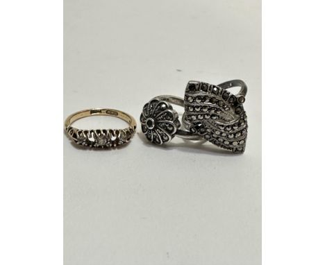 A 18ct gold ring set three diamond points missing two stones, 3.2g and two white metal marquisette set rings(3)