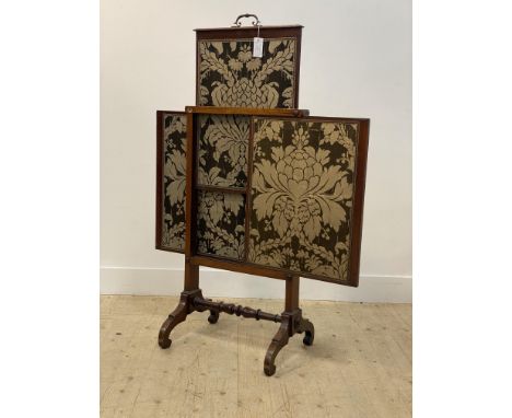 A mid 19th century mahogany metamorphic firescreen, three sliding embroidered silk lined panels, raised on four inverted spla