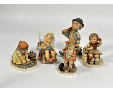 A group of five German Hummel pottery figures including, Mothers Helper, Big House cleaning, Just Dozing, etc., ( Tallest H x