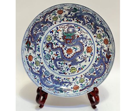 A large modern Chinese polychrome porcelain charger with central roundel depicting five-claw dragon (apocryphal six-character